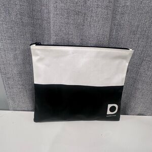 White and black dermstore cosmetic bag with zipper.